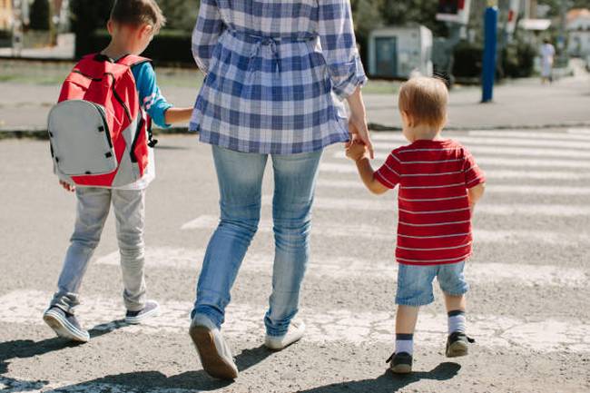 cropped-image-of-a-mother-crossing-a-road-with-her-children