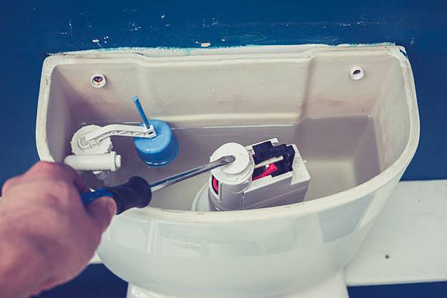 hand-fixing-toilet