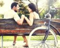 couple-in-love-sitting-together-on-a-bench-with-bikes
