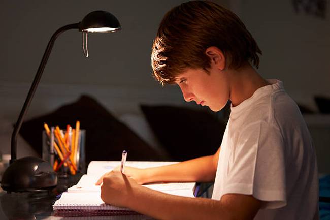 young-boy-studying-at-desk