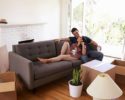 couple-on-sofa-taking-a-break-from-unpacking-on-moving-day