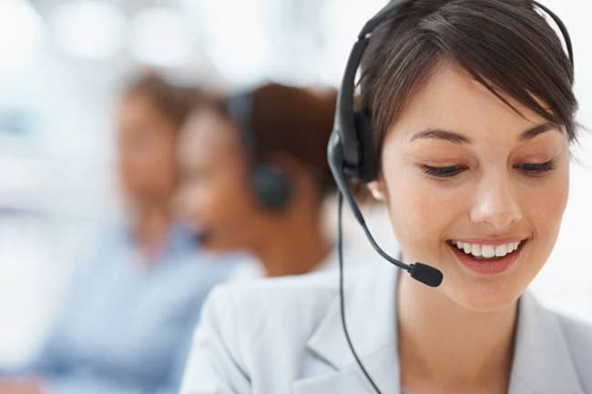 smiling-call-center-employee-during-a-telephone-conversation
